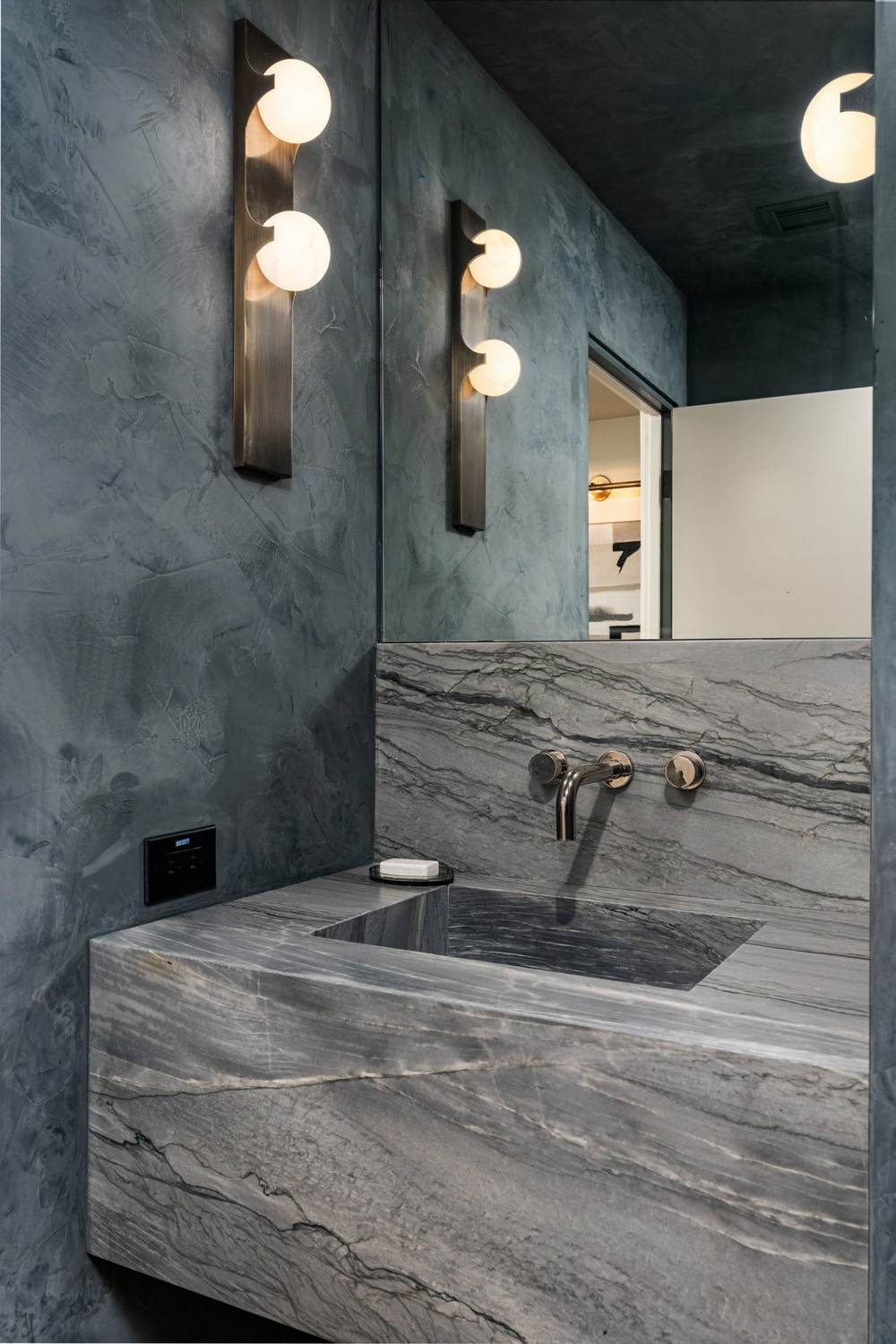 Plaster powder room with stone sink