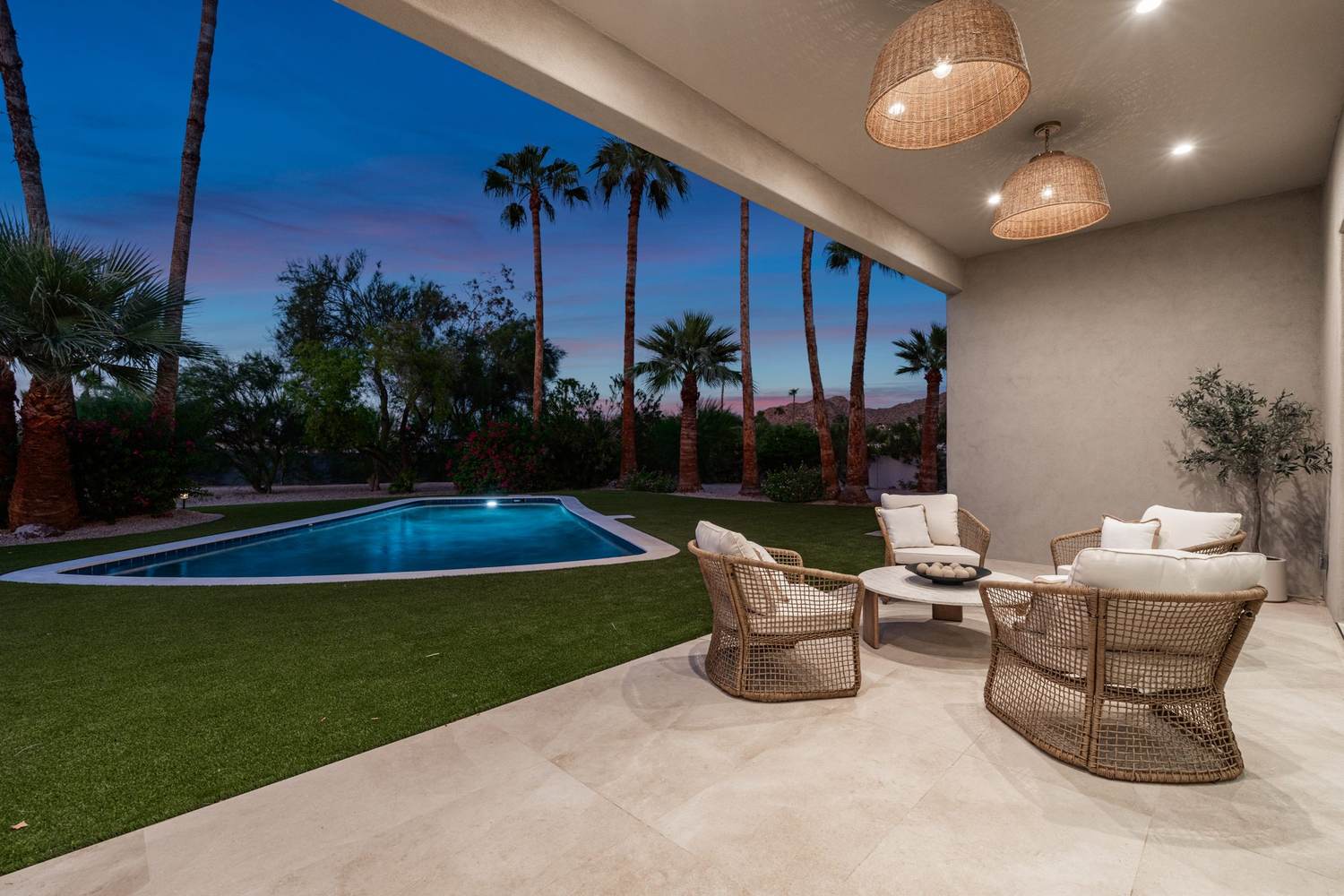 Covered outdoor living overlooking the pool
